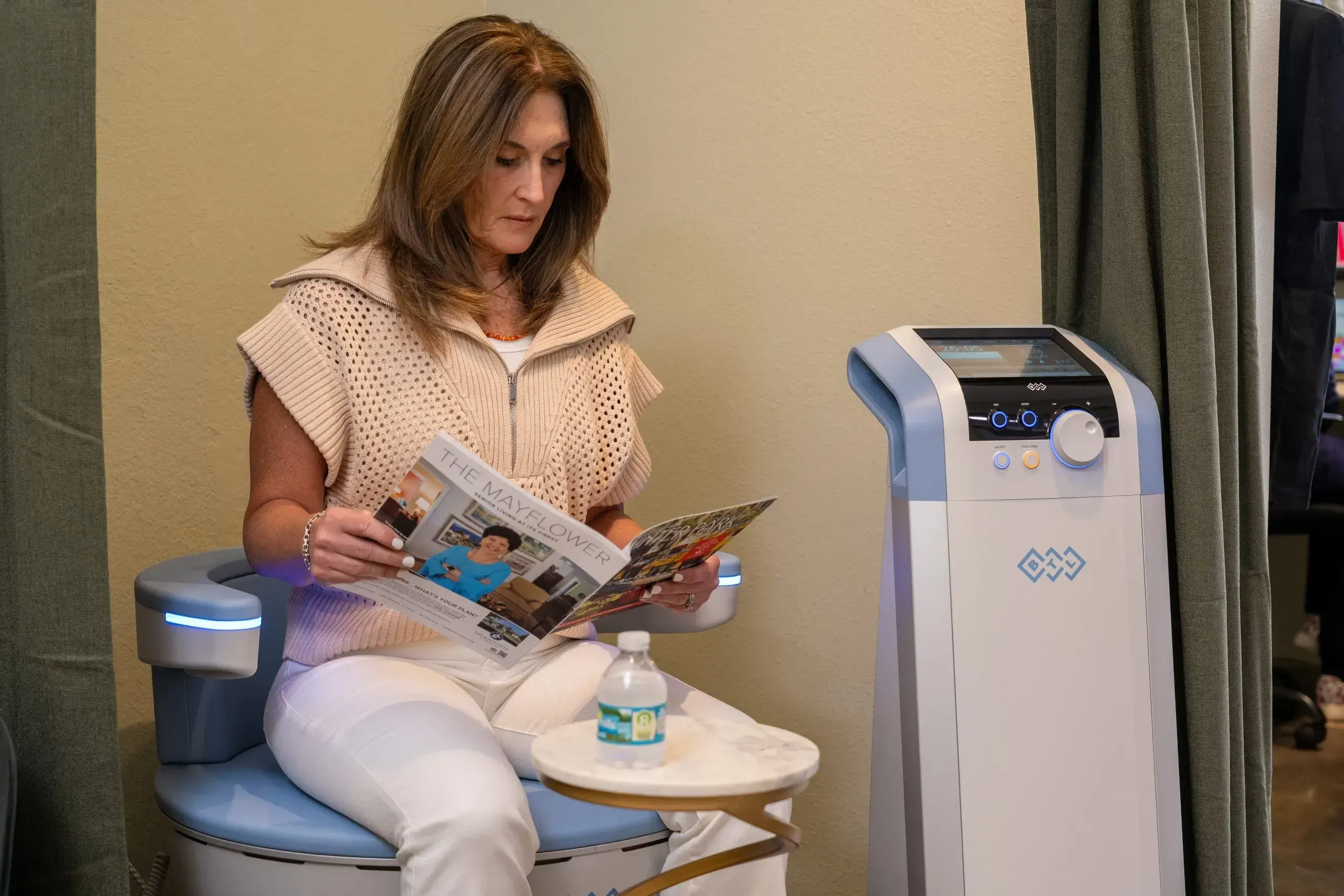 Patient sitting on Emsella chair for non-invasive pelvic floor therapy at Zabinski Urology Melbourne FL