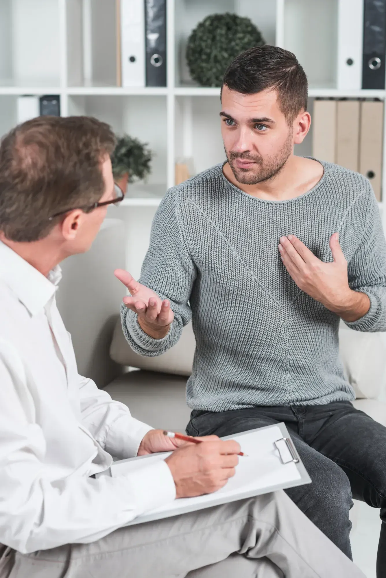 Urologist explaining the benefits of a male infertility evaluation to a patient at Zabinski Urology in Melbourne, FL